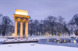 © marcin jucha - Illuminated General Bem Monument in Tarnow, Poland. Magical Winter Snowfall in City Park and Pond at Twilight