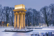 © marcin jucha - Illuminated General Bem Monument in Tarnow, Poland. Magical Winter Snowfall in City Park and Pond at Twilight