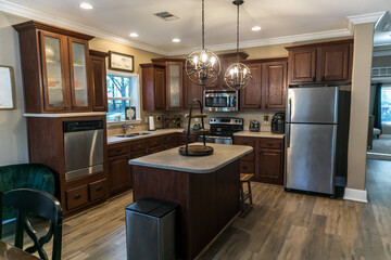 Small renovated dark wood kitchen with center island