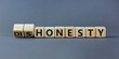 © Dzmitry - Honesty or dishonesty symbol. Turned cube and changed the word 'dishonesty' to 'honesty'. Beautiful grey background. Business and honesty or dishonesty concept. Copy space.