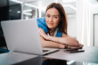 © romankosolapov - Woman on remote work or online education, using laptop computer, making notes, indoors at home. Online business, young professional at workplace. Working from home.