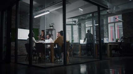 Aufkleber - Project Manager Makes a Presentation for a Young Diverse Creative Team in Meeting Room in an Agency. Colleagues Sit Behind Conference Table and Discuss Business Development, Sales Analysis and Design.
