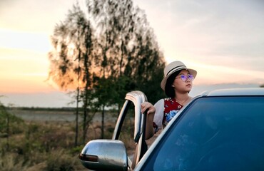 Young woman standing in car of travel holiday weekend.