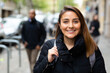 Portrait of smiling young woman walking outside at cold day