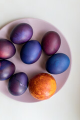 Wall Mural - Painted blue and purple Easter eggs on a textured background. Easter eggs on a plate.