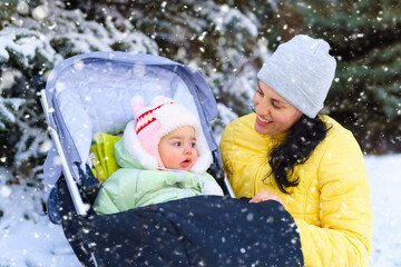 family portrait in the winter forest, mother and baby, bright snowy fir trees, beautiful nature