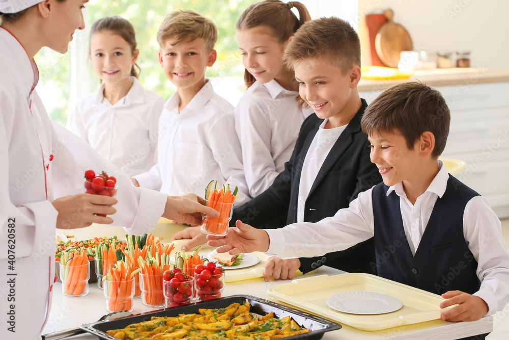 Pupils receiving lunch in school canteen