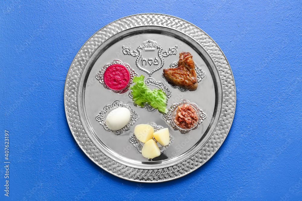 Passover Seder plate with traditional food on color background