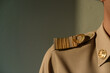 Closeup epaulet of Thai Government Officer, Civil Servant wears Brownish-Yellow uniform.
