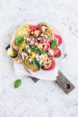 Wall Mural - Tomato salad with basil, feta cheese and olive oil