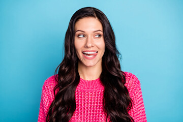 Poster - Portrait of attractive cheerful wavy-haired girl licking lip looking aside copy space isolated over bright blue color background