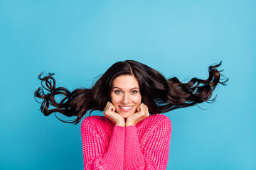 Poster - Photo of cute cheerful lady arms on cheeks beaming smile hair flying isolated on blue color background