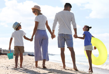 Sticker - Happy family at beach on sunny summer day