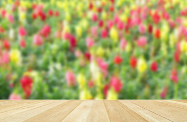 Empty top wooden table on soft blurred flowers fields for nature background