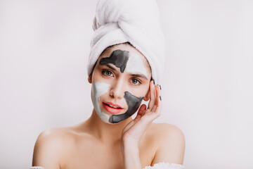 Sticker - Girl uses white and black clay to improve and cleanse skin. Portrait of model in towel after washing her hair