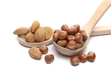 Wall Mural - Hazelnuts and almonds in wooden spoon and ladle, organic nuts isolated on white background