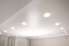 White Stretch Ceiling With Spot Lights In Room