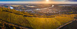 Tokaj, Hungary - Aerial panoramic view of the world famous Hungarian vineyards of Tokaj wine region with town of Tokaj, River Tisza and golden sunrise at background on a warm autumn morning