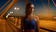 © Roman - Portrait of young confident female runner standing on bridge at twilight. Athletic woman getting ready to start her morning running workout for muscle endurance. Physical activity and health concept