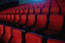 Close Up Shot Of Interior Of Cinema Auditorium With Lines Of Red Chairs