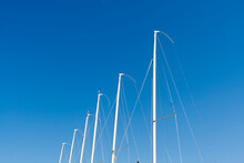 White Masts In Front Of Blue Sky