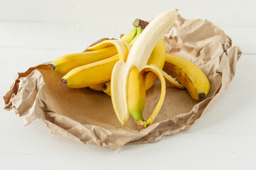 Wall Mural - Ripe bunch of bananas in paper bag. Healthy eating concept