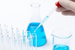 Closeup of a scientist experimenting with blue toxic substances in a laboratory
