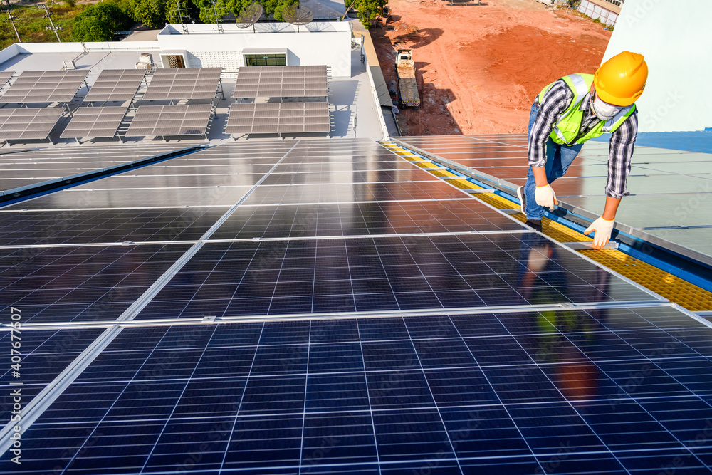 Engineers are examining solar panels in an installation at a power ...