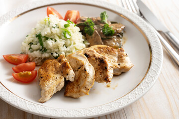 Fried chicken filet with cauliflower rice, tomatoes and mushroom ragout, healthy meal to lose weight with low carb diet