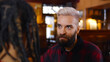 © nimito - Portrait of hipster bearded man talking to african woman sitting in modern bar