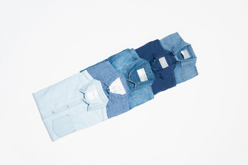 flat lay of blue denim shirts on white background, top view