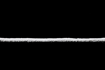 Poster - strip of snow isolated on a black background