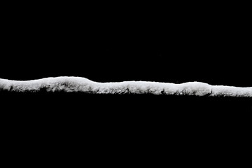 Poster - strip of snow isolated on a black background