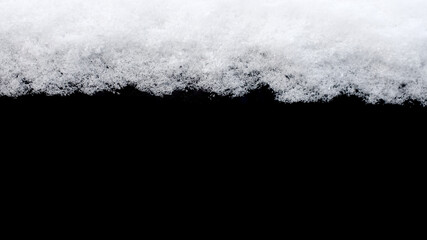 Poster - strip of snow isolated on a black background
