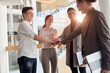 © luckybusiness - satisfied group of colleagues putting hands together one on another making   business team stronger