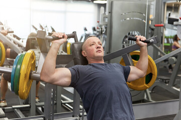 Man in the training gym  working hard after quarantine.