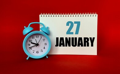 January 27 on a white Notepad .Next to it is a blue clock on a red background.Calendar for January .