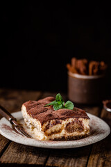 Wall Mural - Piece of traditional Italian dessert tiramisu on dark background