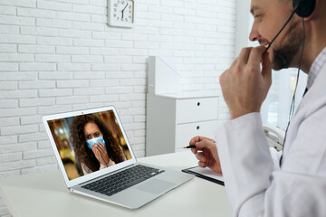 Poster - Hotline service. Doctor consulting patient online via laptop indoors