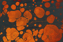 Texture Of Paper Marbling Design Pattern In Dark Gray And Orange Colors
