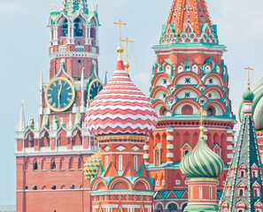 Spasskaya Tower of Moscow Kremlin and domes of the Cathedral of Vasily the Blessed (Saint Basil's Cathedral) on Red Square. Close-up. Moscow. Russia