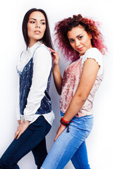 Wall Mural - best friends diverse races teenage girls together having fun, asian and african , posing emotional on white background, lifestyle people concept