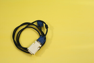 Canvas Print - Top view of a computer component wire cable with its adapter isolated on a yellow background