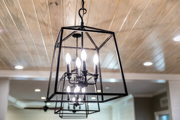 Hanging black metal iron lighting fixtures in a newly renovated kitchen