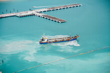 Suction Dredger Ship Working Near The Port - With Mud, Pollution, Brown Muddy Water - Aerial Shot