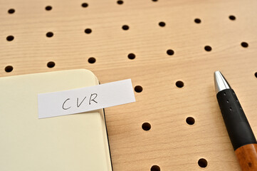 Leinwandbilder - A sticky note with CVR written on the edge of an open notebook on the punching board. That's an acronym for Conversion Rate.