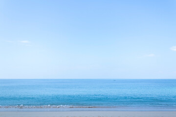  View of the sandy beach, summer sea and blue sky.