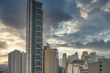 Wall Mural - Office building and apartment in Makati City under dramatic cloudy sky