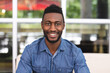 © Wavebreak Media - Portrait of african american man sitting in a cafe looking at camera and smiling