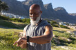 © Wavebreak Media - Fit senior african american man exercising wearing earphones checking smartwatch